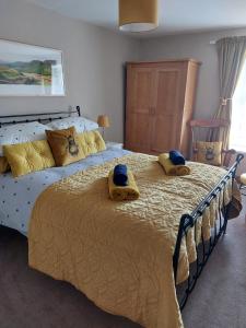 a bedroom with a large bed with towels on it at Heart Of Hawes Holiday Cottage in Hawes