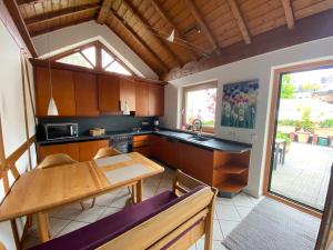 a kitchen with a wooden table and a dining room at Ferienwohnung Lodge 43 in Trier