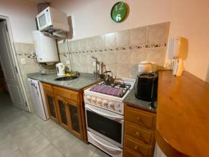 a kitchen with a stove and a counter top at Apartamento San Martín de los Andes in San Martín de los Andes +11 photos