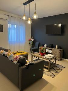 a living room with a couch and a table at La belle etoile in Nibas