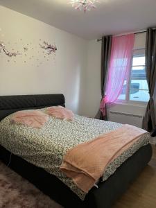 a bedroom with a bed and a window at La belle etoile in Nibas