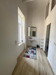 a bathroom with a sink and a mirror at Zentrale & flexible Unterkunft II in Wilhelmshaven +3 photos