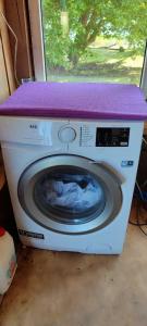 a washing machine with a purplevisor on top of it at Pie Ventas in Ventspils