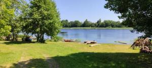 a view of a lake with two boats on it at Pie Ventas in Ventspils
