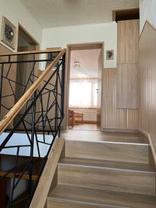 a staircase leading to a room with a window at Ubytování Šustovka in Třeboň +25 photos