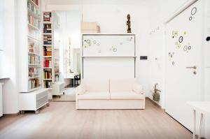 een woonkamer met een witte stoel en een whiteboard bij Design Apartment - Milano City Center - Duomo in Milaan