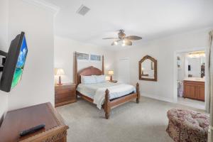 a bedroom with a bed and a tv and a bathroom at Pet-friendly waterfront home near beach with pool in Marco Island +52 photos