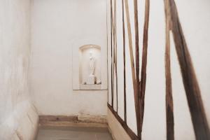 a hallway with a mirror and a statue on a wall at Un Mas en Ville in Marseille +77 photos