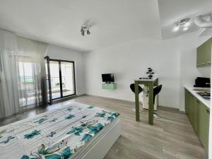 a bedroom with a bed and a desk in a room at Sea and lake view- Casa del Mar in Mamaia Nord
