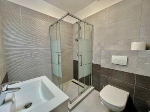 a bathroom with a sink and a toilet at Sea and lake view- Casa del Mar in Mamaia Nord +2 photos