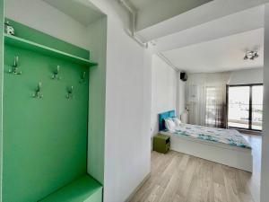 a room with a bed and a green wall at Sea and lake view- Casa del Mar in Mamaia Nord
