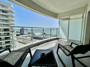 a balcony with chairs and a table and a view of the ocean at Sea and lake view- Casa del Mar in Mamaia Nord