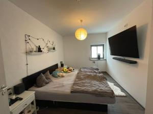 a bedroom with a bed with stuffed animals on it at Spessart Oase in Marktheidenfeld +15 photos