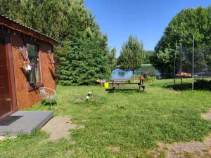 a park with a picnic table and a bench at Pie Ventas in Ventspils +9 photos