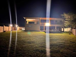 a large house at night with a frisbee at Langelihle- Margate Accommodation in Margate