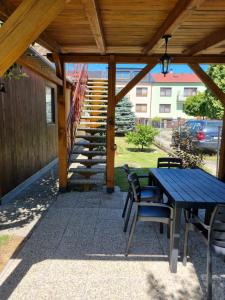 a patio with a table and chairs and stairs at Ubytování Šustovka in Třeboň