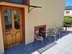 a patio with tables and chairs next to a door at Ubytování Šustovka in Třeboň