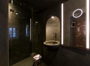 y baño con bañera y ducha con lavamanos. en Townhouse Weisses Kreuz en Salzburgo
