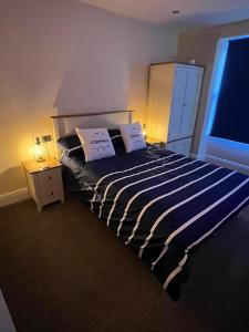 a bedroom with a bed with two pillows on it at Seagull Cottage in Looe