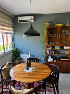 a dining room with a wooden table and chairs at Midcentury modern 1 bedroom apartment in Tirana in Tirana
