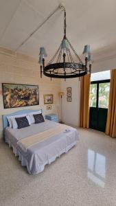 ein Schlafzimmer mit einem großen Bett und einem Kronleuchter in der Unterkunft Grand Harbour View in Valletta