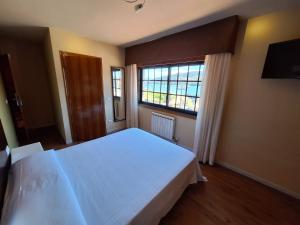 Łóżko lub łóżka w pokoju w obiekcie Hostal O Galeón San Luis