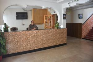 a man sitting at a counter in a room at Besham Inn, Besham in Besham