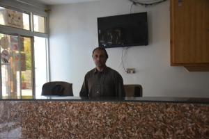 a man sitting at a counter in a room at Besham Inn, Besham in Besham