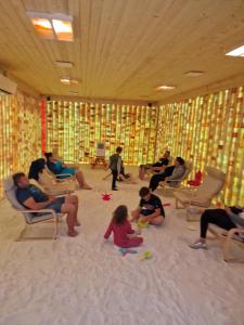 a group of people sitting in chairs in a room at Casa Piri in Anina