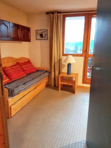 a small bedroom with a bed and a window at Studio avec balcon a Vallandry in Landry