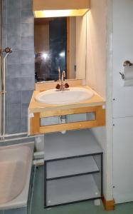 a bathroom with a sink and a mirror at Studio avec balcon a Vallandry in Landry