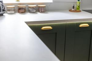 a kitchen with green cabinets and a white counter top at Flour Mill House - Pitkerro Mill in Dundee
