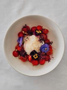 a white bowl of food with flowers and rice at Pousadela Village in Vieira do Minho