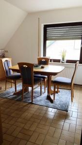 a dining room with a table and chairs and a window at IIA Apartments in Warzen