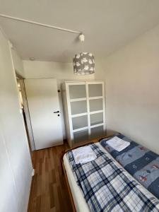 a bedroom with a bed and a door at Myklebostad in Steigen