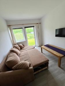a bedroom with a large bed and a flat screen tv at Myklebostad in Steigen