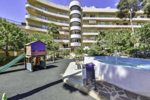 an empty playground in front of a large building at Apartment Sunset Moraira City in Moraira