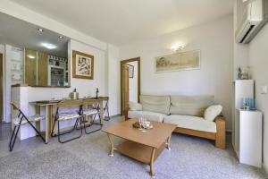 a living room with a couch and a table at Apartment Sunset Moraira City in Moraira