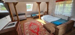 a small room with a bed and a couch at Oliwkowe Jerzykowo -klimatyzacja in Radzieje