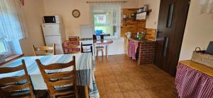 a kitchen with a table and chairs in a kitchen at Oliwkowe Jerzykowo -klimatyzacja in Radzieje