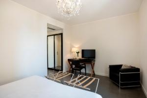 a bedroom with a bed and a desk with a chair at Hotel Palazzo Cavalieri in Syracuse