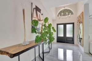 a hallway with a table with a plant on it at Privacy Pool Gulf Access and Luxury in Bonita Springs