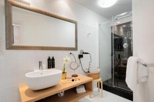 a bathroom with a sink and a shower at Hotel Palazzo Cavalieri in Syracuse