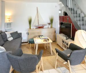 een woonkamer met een bank en een tv bij Maison de 2 chambres avec jardin clos et wifi a Sainte Anne d'Auray in Sainte Anne d'Auray 