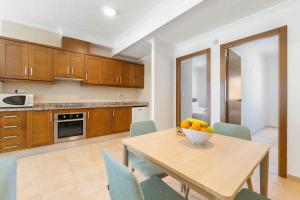 a kitchen with a table with a bowl of fruit on it at Finca Santa Barbara in Elche +42 photos