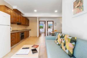 a living room with a blue couch in a kitchen at Finca Santa Barbara in Elche