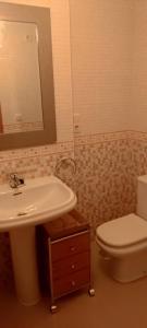a bathroom with a sink and a toilet and a mirror at playa portonovo in Portonovo +10 photos