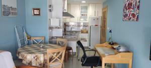 a kitchen with a table and a dining room at playa portonovo in Portonovo