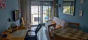 a room with a table and chairs and a window at playa portonovo in Portonovo