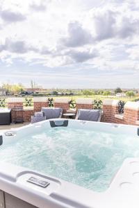 a hot tub on a balcony with a view at South Lodge, St Osyth Priory in Saint Osyth